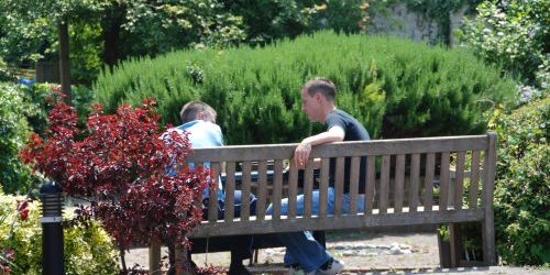 Photograph of keyworker and client sitting on bench