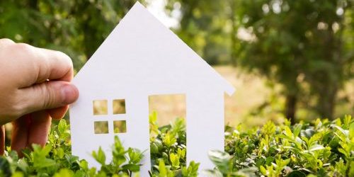 Photograph of hand holding model house